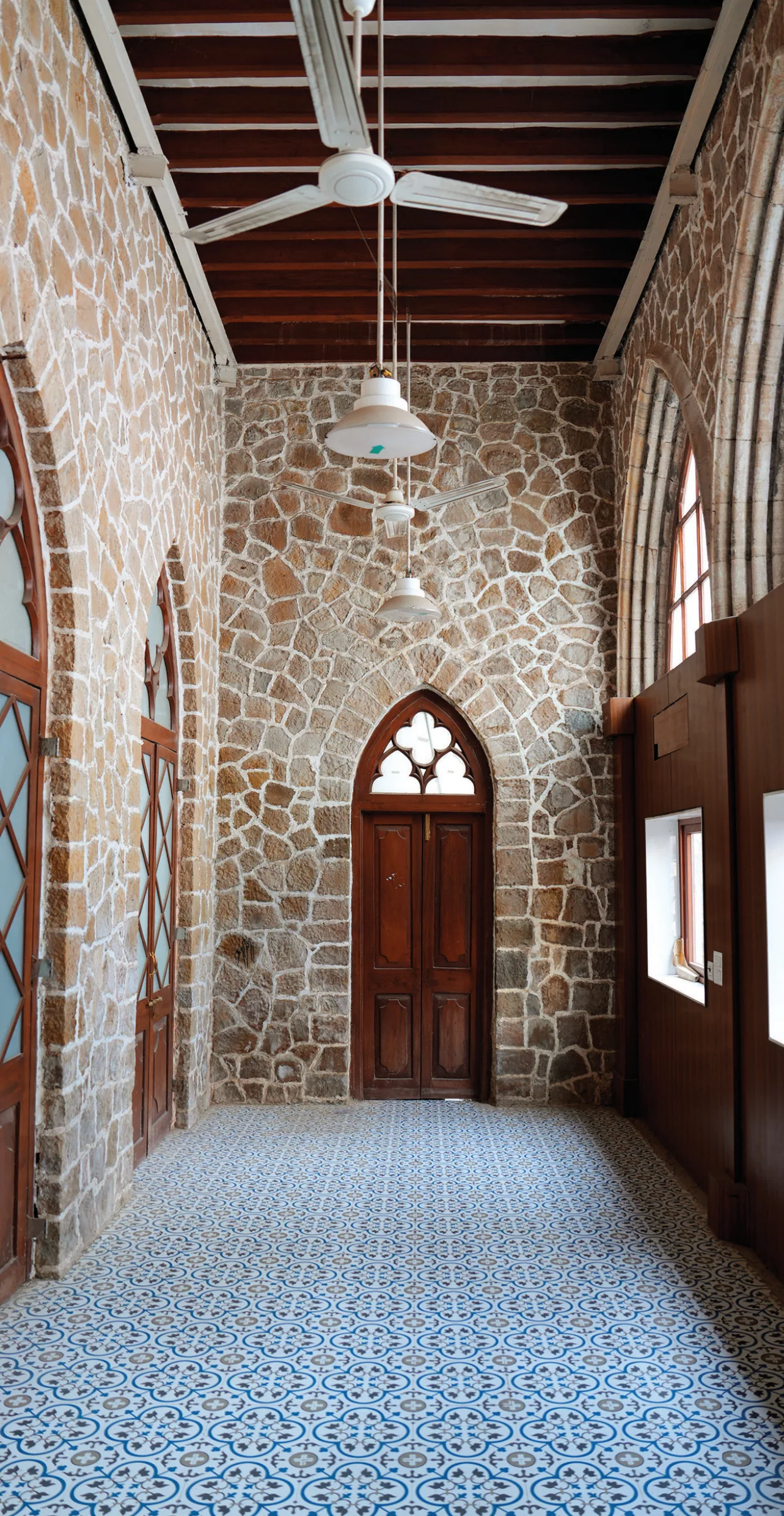Stone masonry with teakwood accents and details in the heritage structure of the Boys Common Room